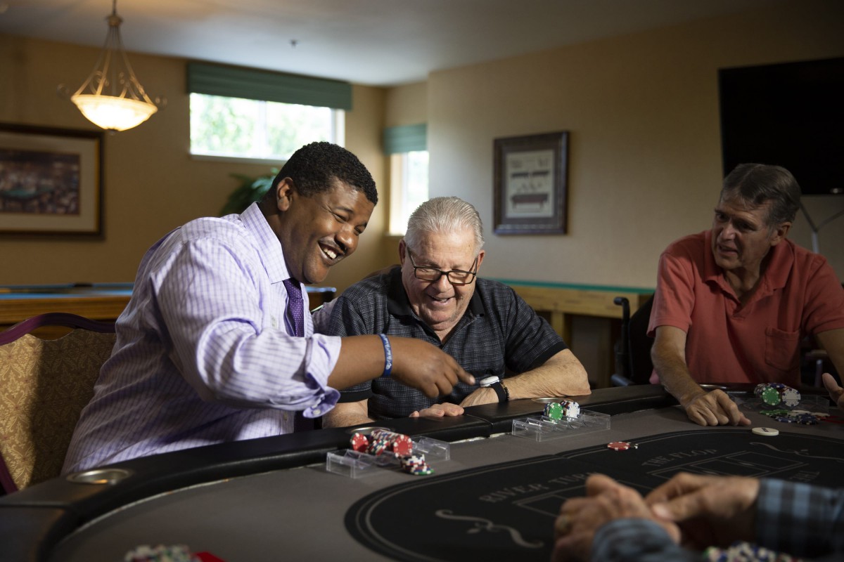 A group of people enjoying a poker game indoors.