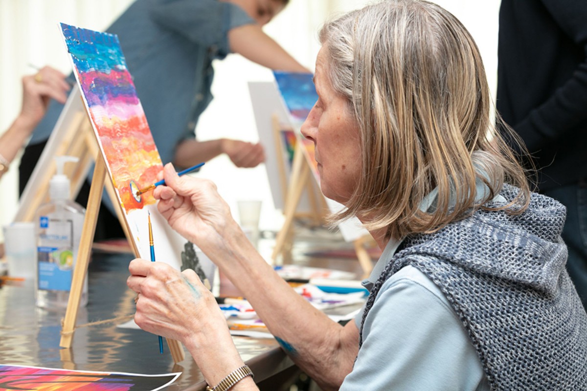 A person engaged in painting at an art workshop.