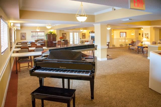 A cozy lobby featuring a grand piano and seating area.