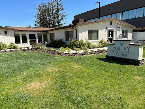 A well-maintained facility with landscaped gardens and clear signage.