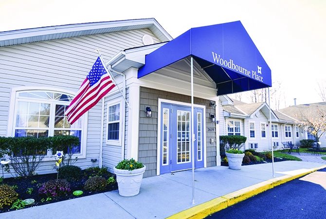 Entrance of a building with an awning and American flag.