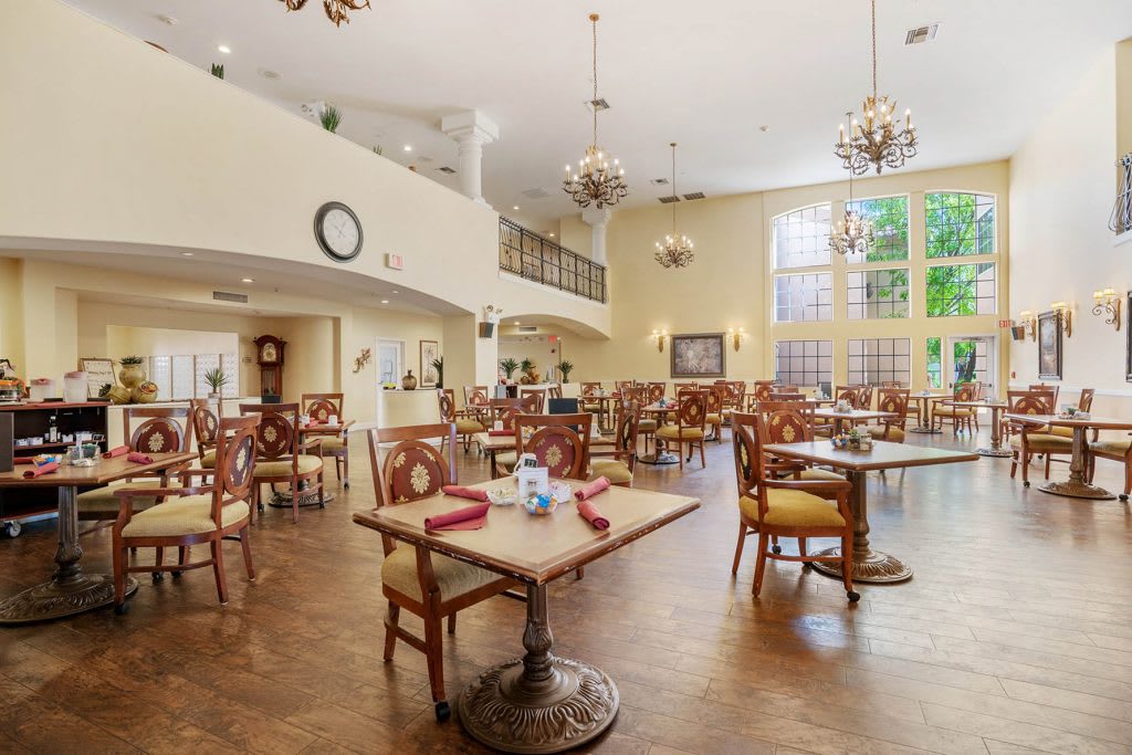 A spacious and well-lit dining room with elegant furnishings and decor.