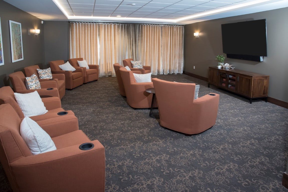 A modern home theater setup with comfortable recliner chairs and a large screen.