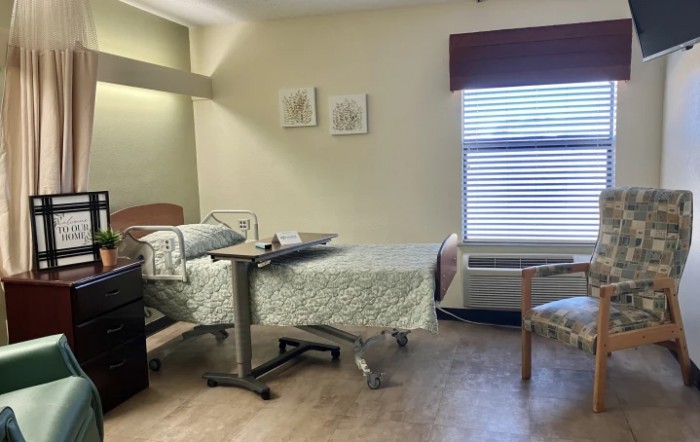 A hospital room with a bed, medical equipment, and a window.