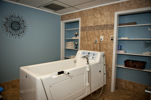A serene spa-like bathroom featuring a modern tub and organized shelves.