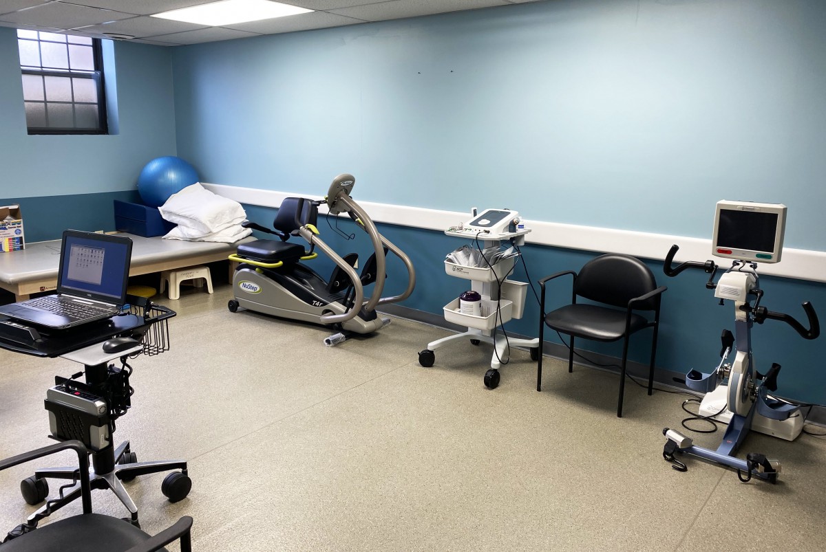 A therapy room equipped with various exercise machines and medical devices.