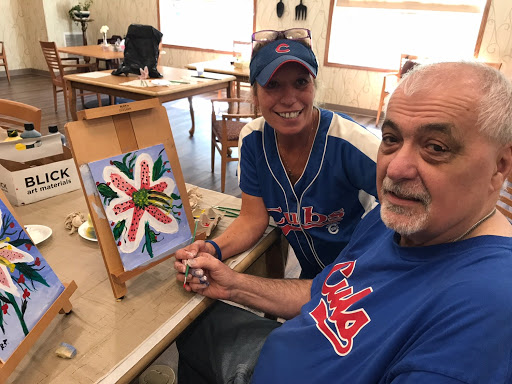 A joyful moment shared as a couple enjoys painting together.