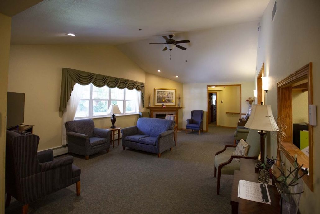 A cozy living room with comfortable seating and natural light from a large window.