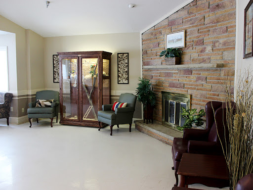 A cozy living room featuring a fireplace, comfortable seating, and decorative elements.