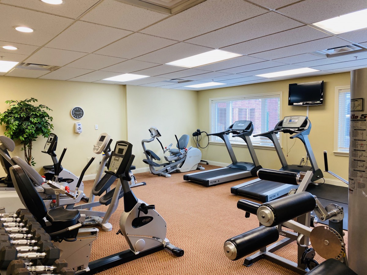 A well-equipped gym with treadmills, exercise bikes, and other fitness equipment.