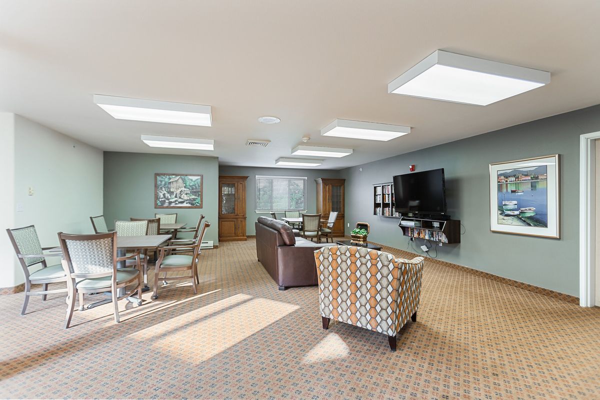 A modern living room with comfortable seating, a television, and stylish decor.