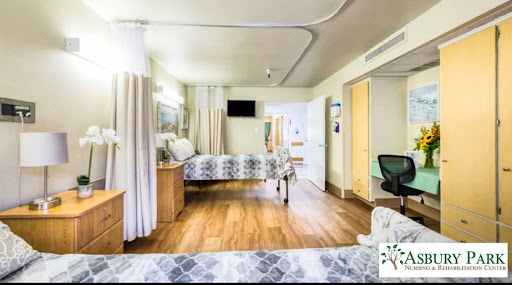 A spacious and well-lit hospital patient room equipped with essential furniture for comfort and care.
