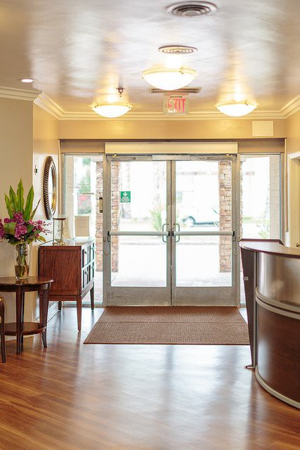 A well-decorated lobby with modern furnishings and a glass entrance.