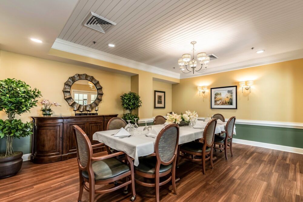 A well-lit dining room with a set table and elegant decor.