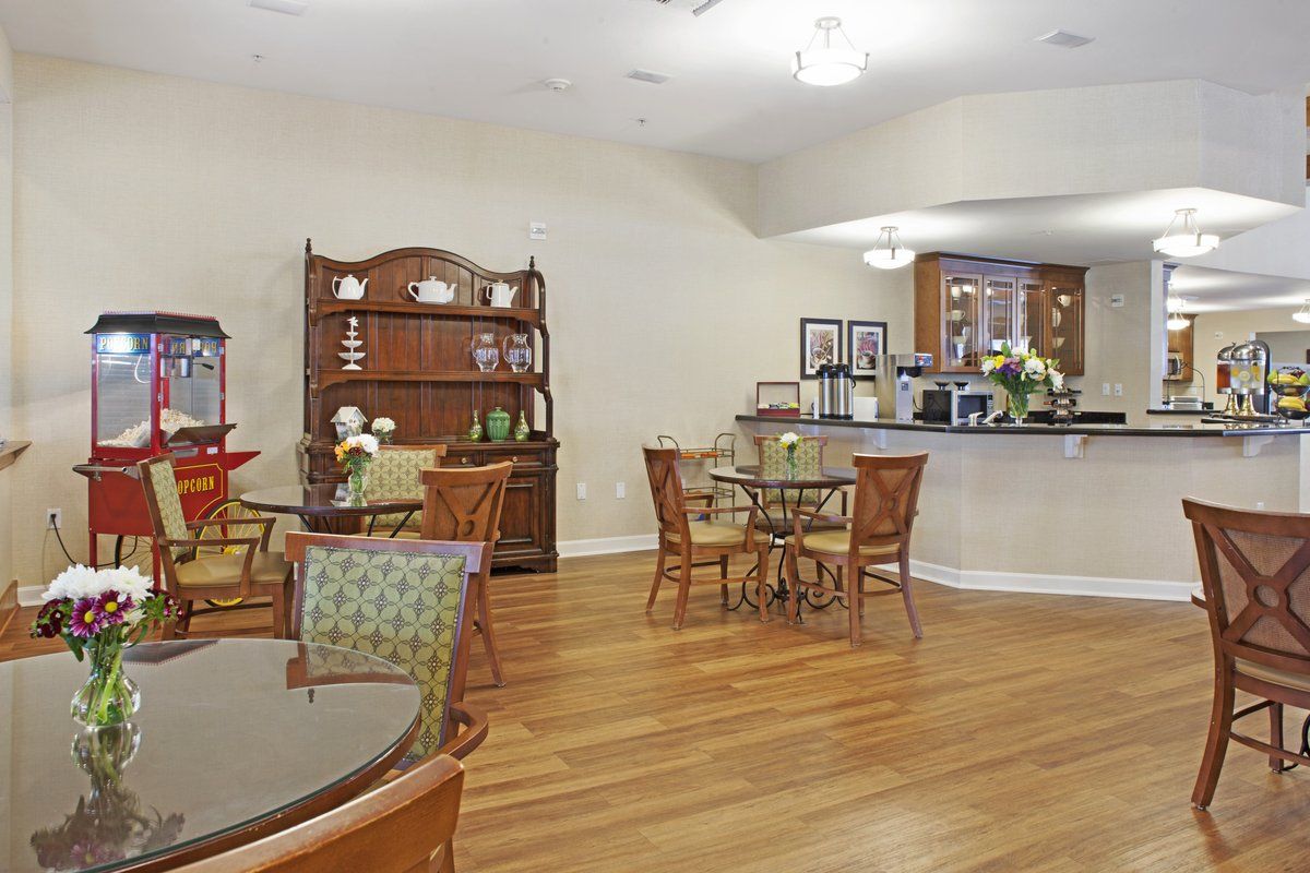 A cozy cafe interior with wooden tables and chairs, complemented by elegant decor and warm lighting.