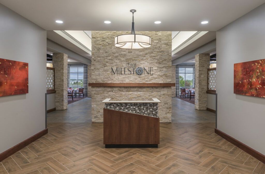 A modern reception area featuring a stone wall, decorative lighting, and contemporary design elements.
