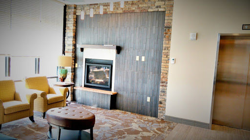 A cozy living room featuring a stylish fireplace and modern decor.