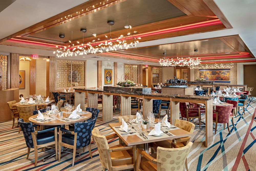 A beautifully designed restaurant dining area with elegant chandeliers and neatly arranged tables.
