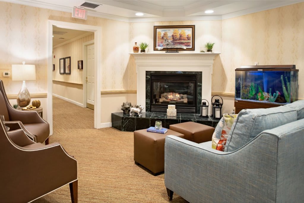 A cozy living room with a fireplace and comfortable seating.