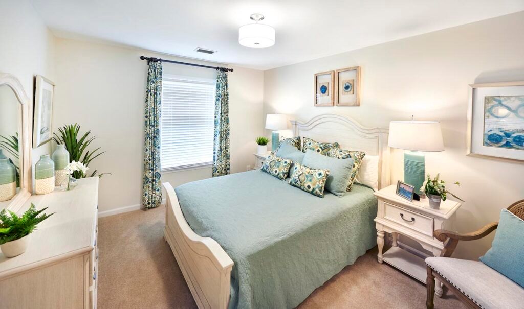 A cozy and elegantly decorated bedroom with soft lighting and coordinated decor.