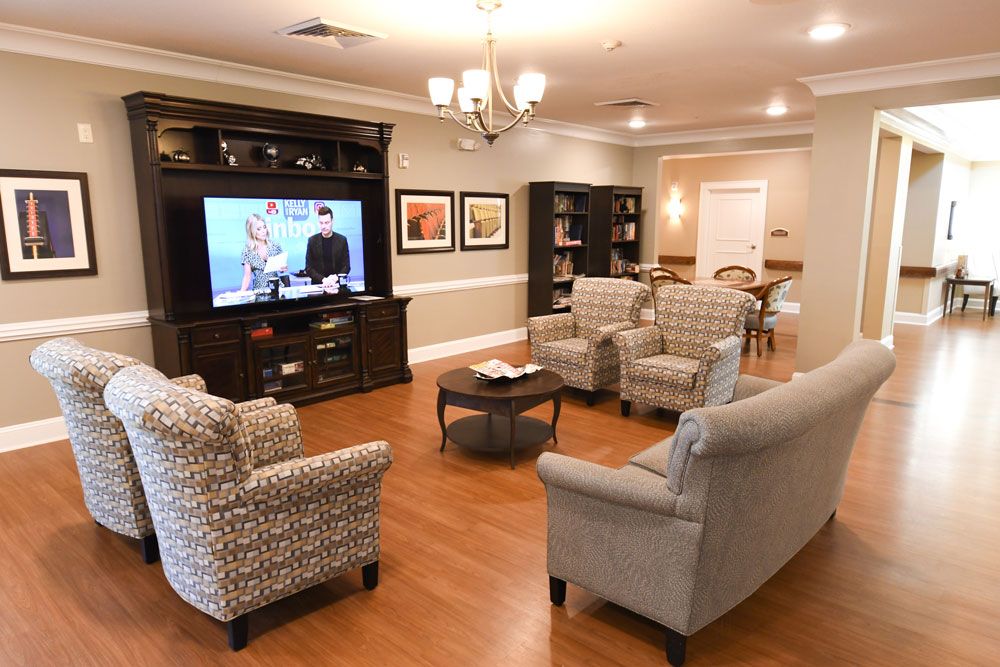 A cozy living room with comfortable seating and a large TV for entertainment.
