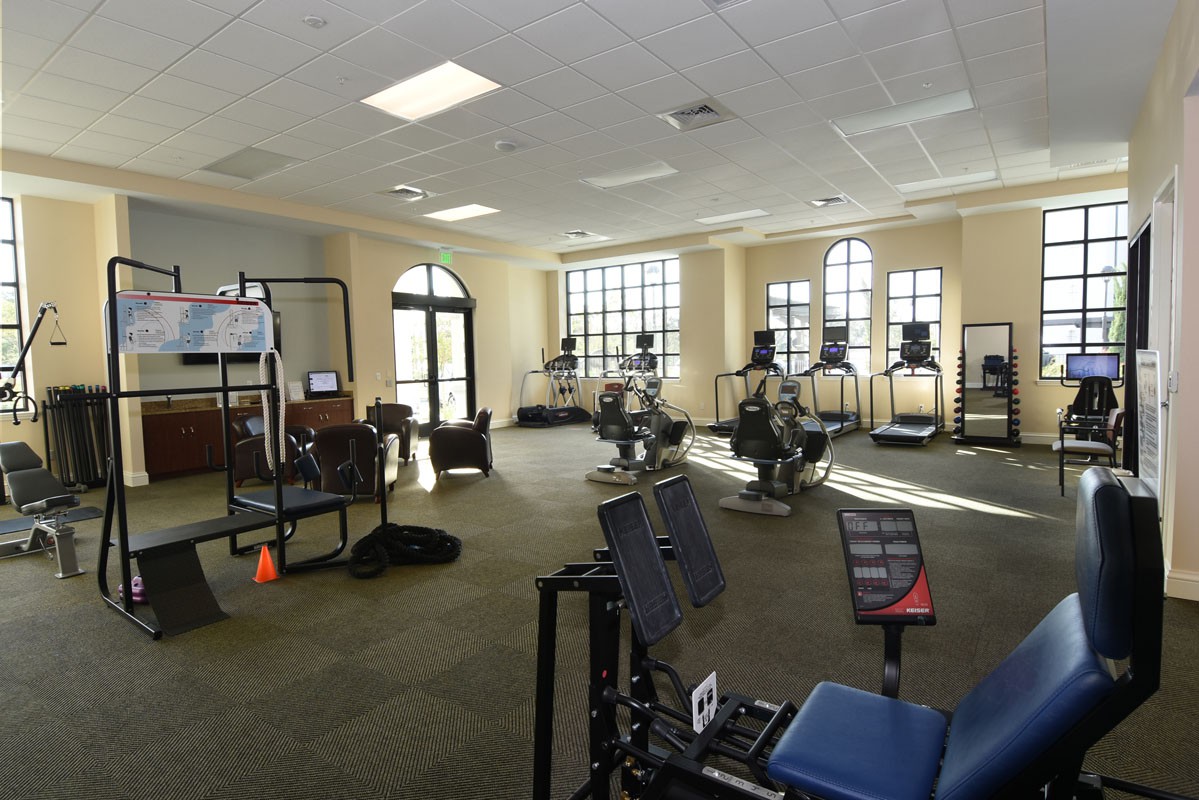 A spacious gym with various fitness equipment and exercise machines.