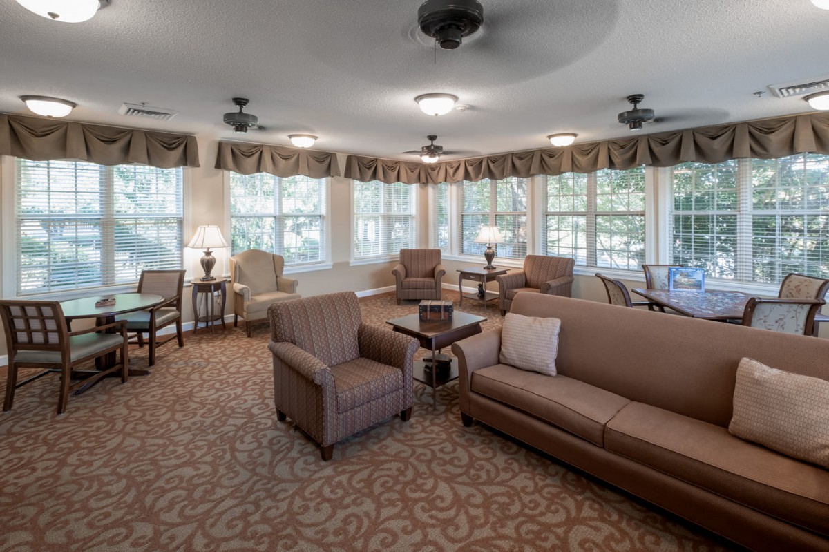 A cozy living room with comfortable seating and large windows letting in natural light.