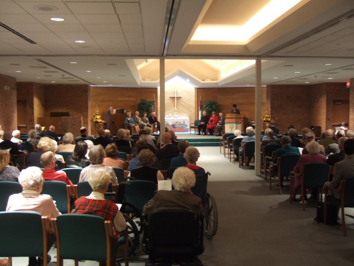 An audience gathered in a church setting for an event.