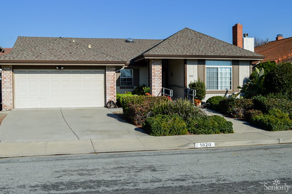 A suburban single-story house with a driveway and garage.