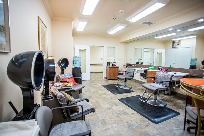 A brightly lit hair salon with chairs and mirrors, ready for clients.