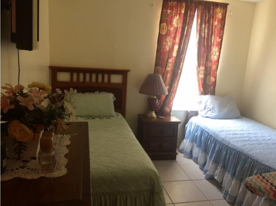 A cozy bedroom with two single beds and a warm atmosphere.