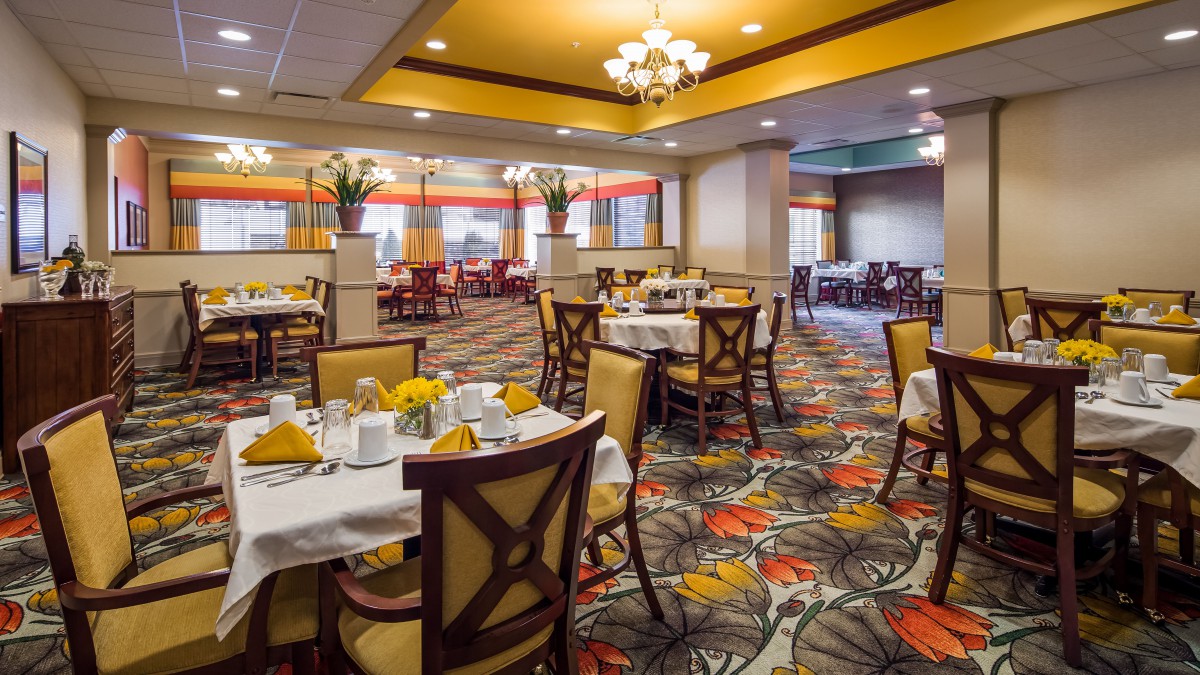 An elegant restaurant dining room with beautifully set tables and vibrant decor.