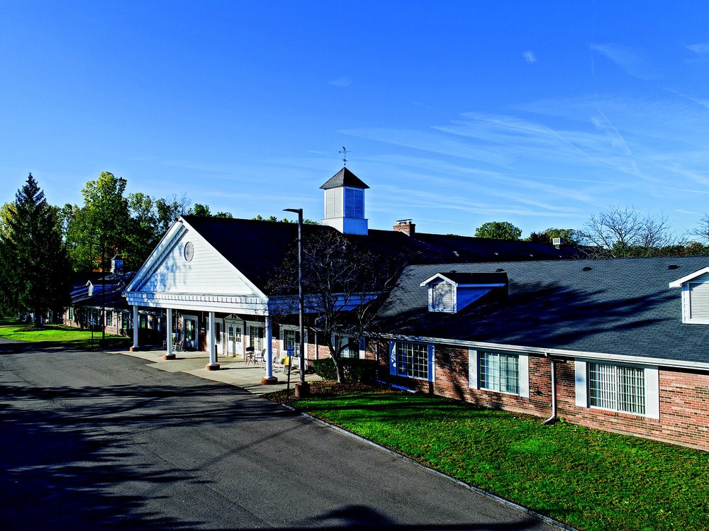 A picturesque view of a residential building against a clear blue sky.