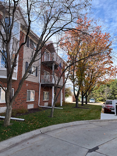 A cozy apartment building surrounded by autumn trees.