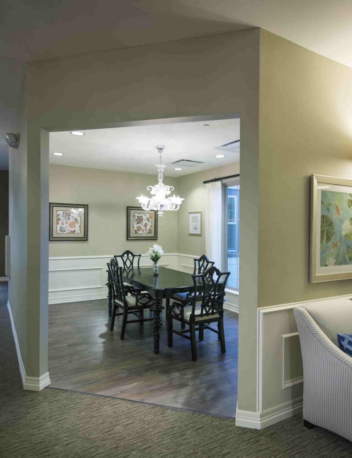 A cozy dining room featuring elegant furniture and ambient lighting.