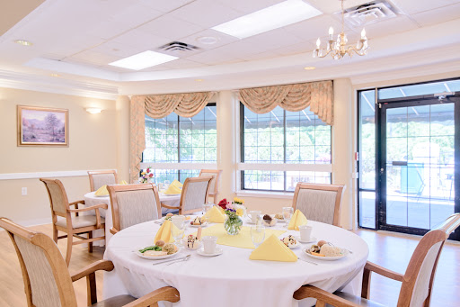 A beautifully arranged dining room with elegant table settings and ample natural light.