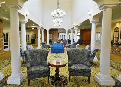 Elegant lobby interior with classic furniture and chandeliers.