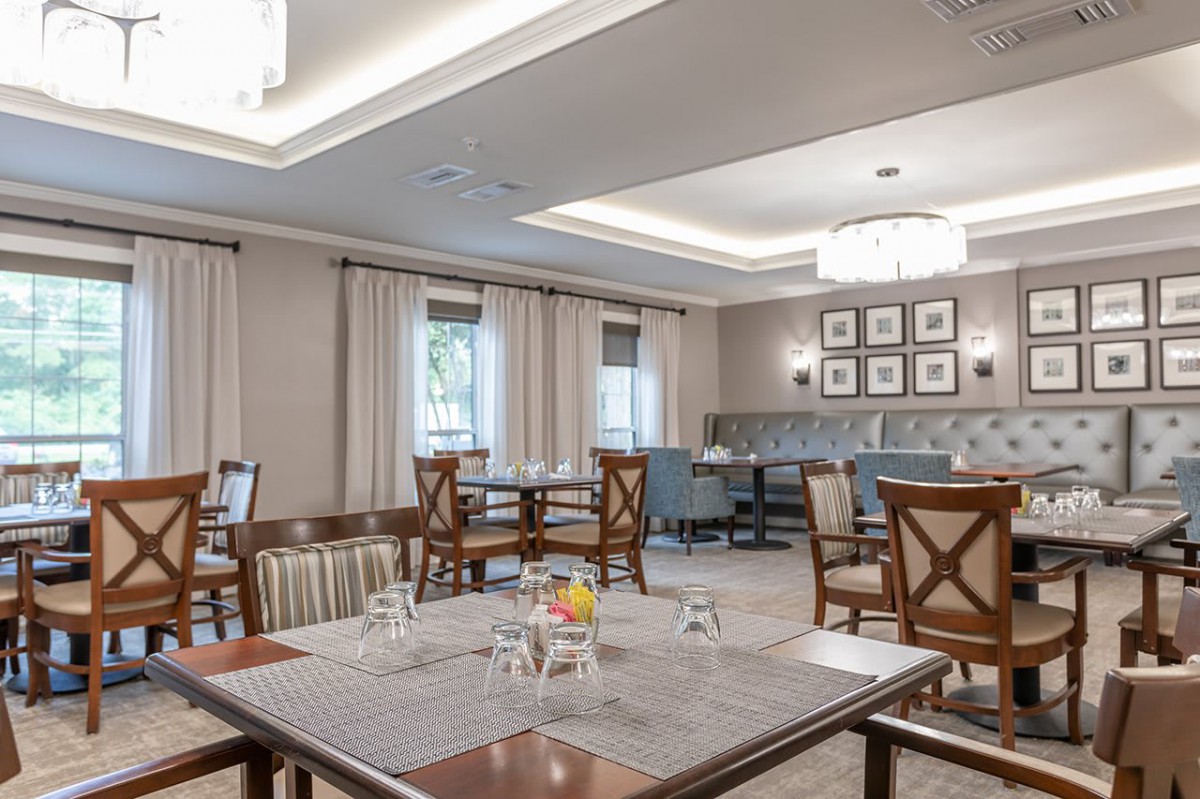 A modern dining room with neatly arranged tables and chairs.