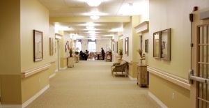 A well-lit hallway with seating and decor.