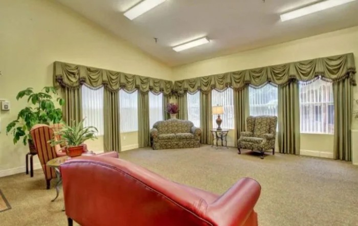 Traditional living room with elegant furnishings and large windows.