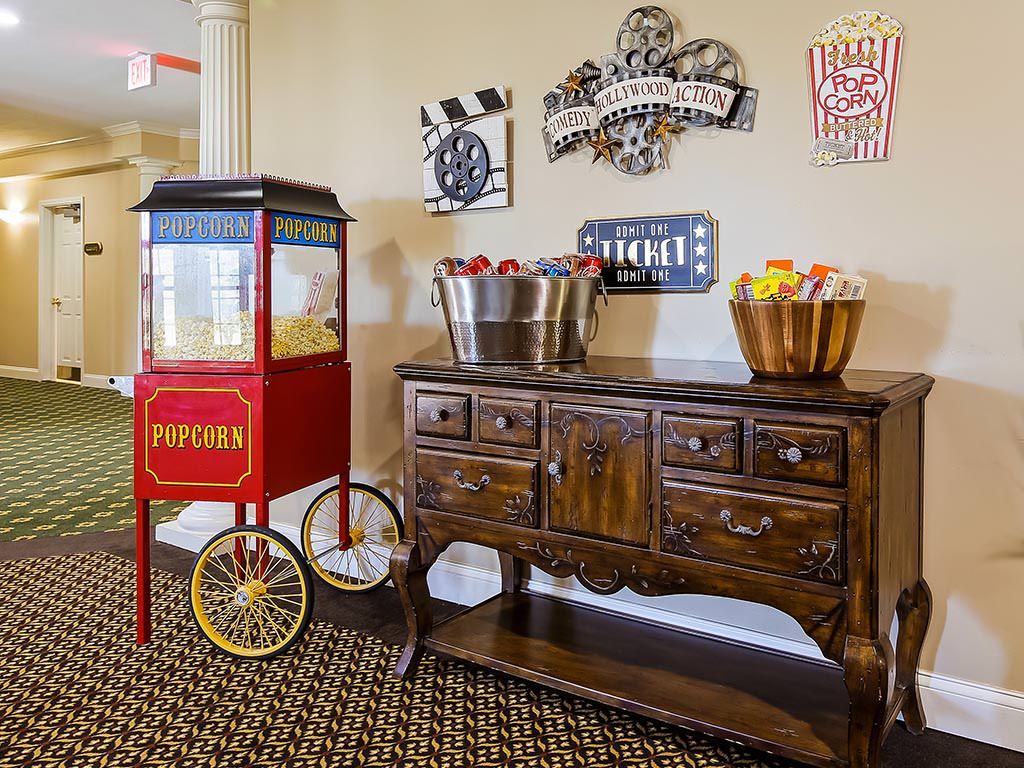 A cozy home theater concession stand featuring a vintage popcorn machine and classic movie decor.