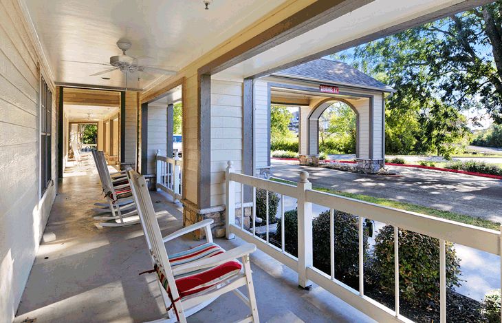 A quaint porch with rocking chairs offers a relaxing spot to enjoy the outdoor view.