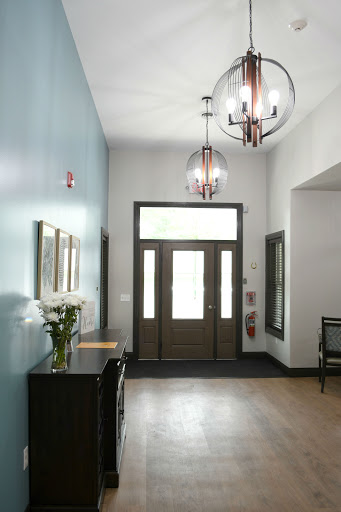 A modern entrance lobby featuring stylish chandeliers and a welcoming atmosphere.