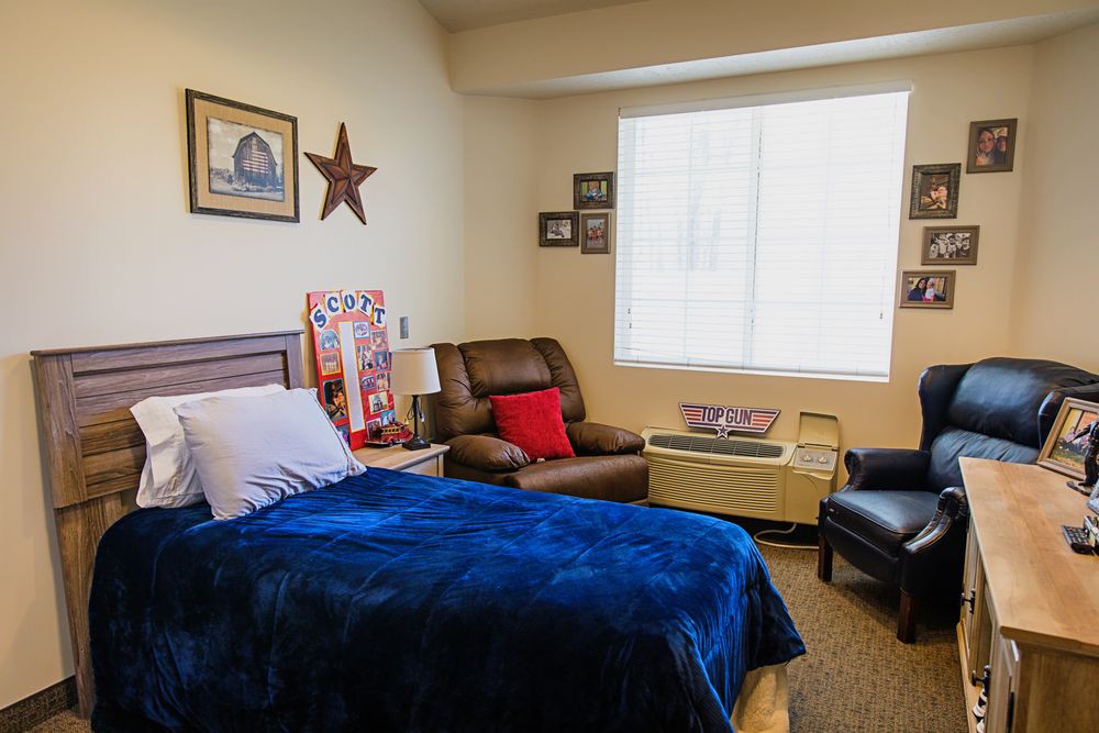 A cozy bedroom with comfortable seating and decorative elements.