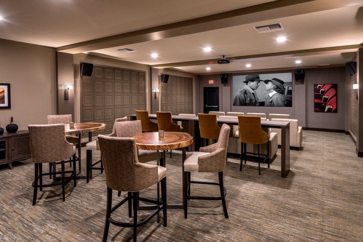A cozy home theater with comfortable seating and a large screen for movie viewing.