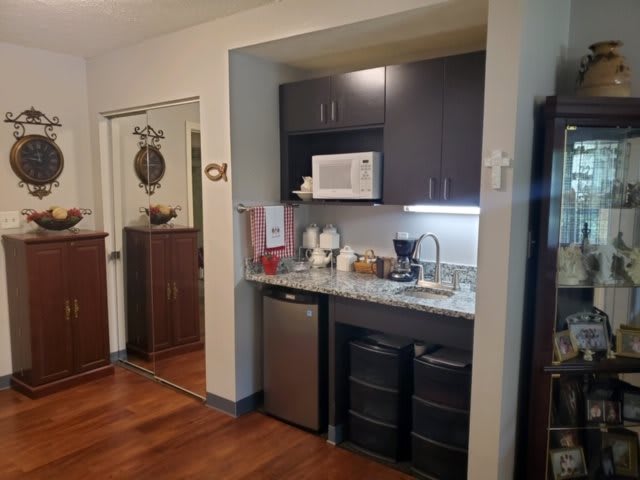 Compact kitchenette with appliances and storage space.