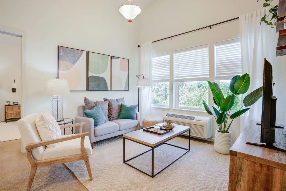 A bright and modern living room with elegant furnishings and natural light.