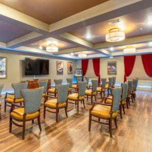 A well-lit conference room with arranged seating and decor.