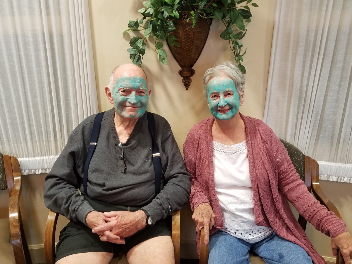 An elderly couple enjoying a relaxing day indoors with facial masks.