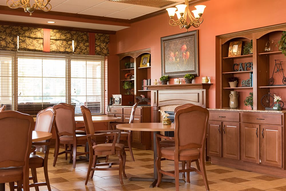 A cozy dining room with wooden furniture and warm-toned walls.